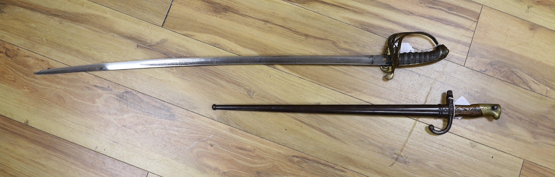 A Victorian officer's sword, lacking sheath, together with a 19th century French ’1877’ bayonet and sheath